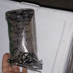 Michael Kors silver mirror signature MK zipper pouch with gun metal hardware.